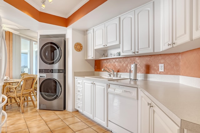 kitchen featuring white cabinets, dishwasher, backsplash, stacked washing maching and dryer, and crown molding