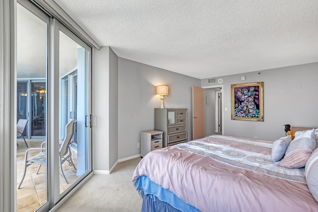 bedroom with light colored carpet, a textured ceiling, and access to exterior