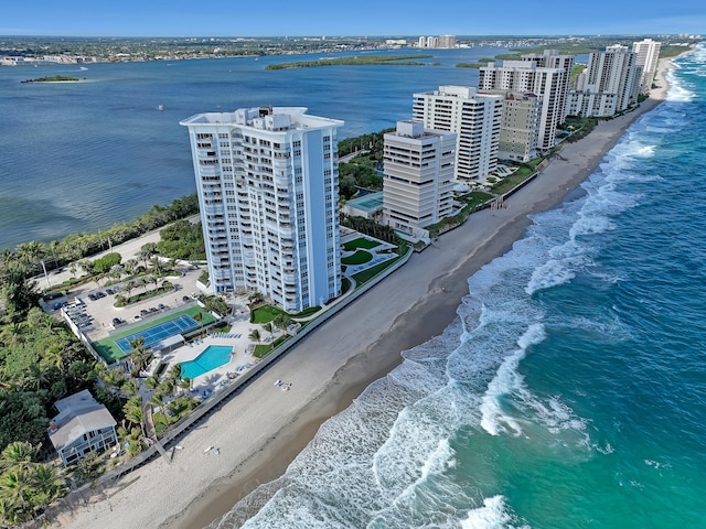 drone / aerial view featuring a beach view and a water view