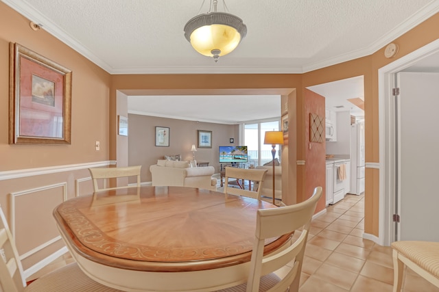 tiled dining space featuring crown molding and a textured ceiling