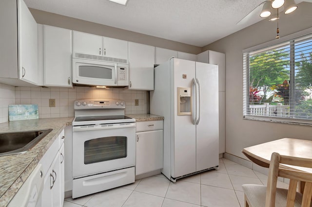 kitchen with white cabinetry, a textured ceiling, white appliances, decorative backsplash, and light tile patterned floors