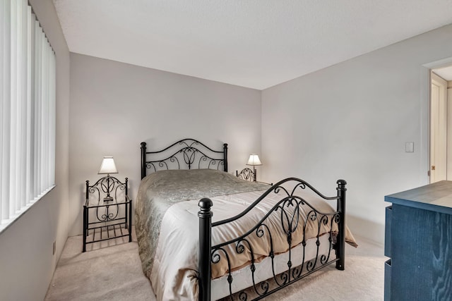 bedroom featuring light colored carpet