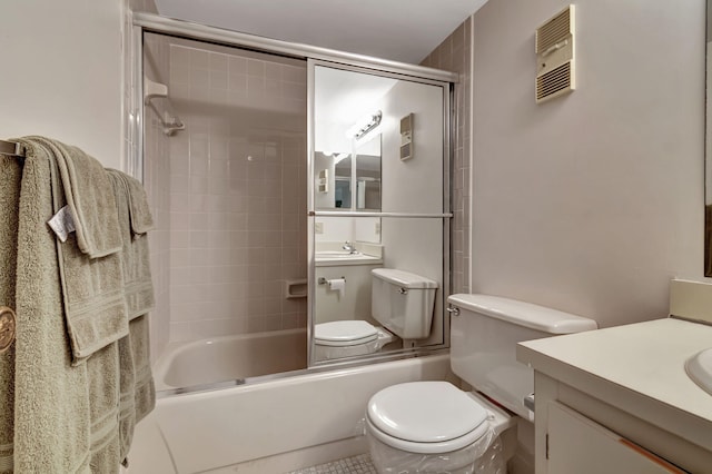 full bathroom featuring tile patterned flooring, vanity, toilet, and combined bath / shower with glass door