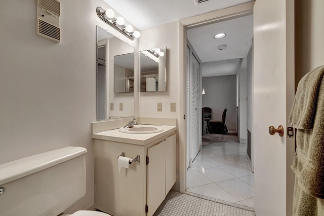 bathroom with tile patterned floors, vanity, and toilet