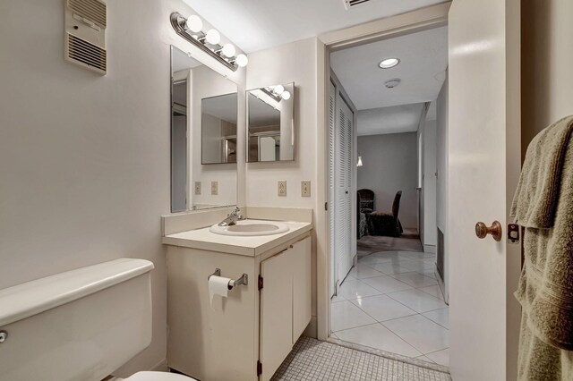 bathroom with toilet, vanity, tile patterned flooring, and recessed lighting