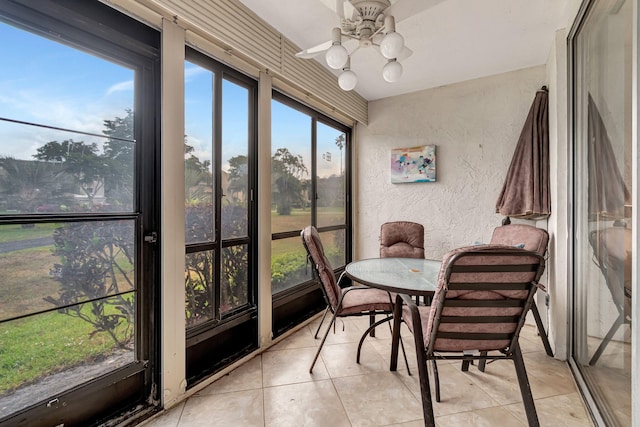 sunroom / solarium featuring ceiling fan