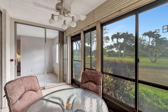 sunroom featuring ceiling fan