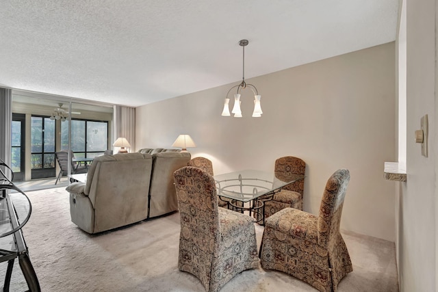 carpeted dining room with a textured ceiling and an inviting chandelier