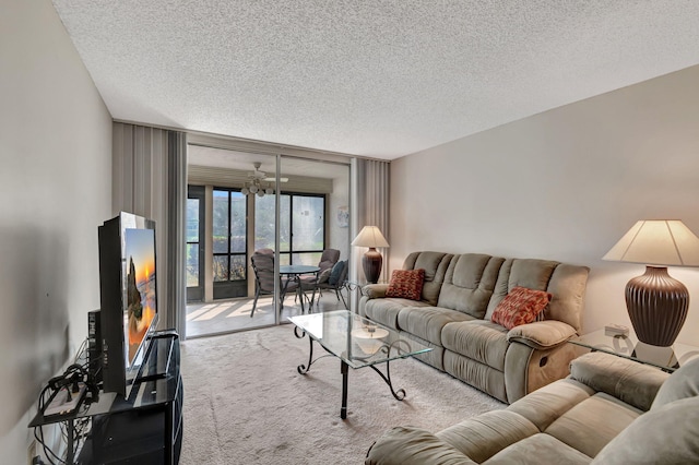 6795 Huntington Ln Unit 107, Delray Beach, FL 33446 - carpeted living area with a textured ceiling, floor to ceiling windows, and a chandelier