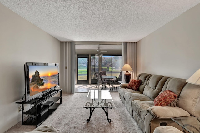 carpeted living room with ceiling fan and a textured ceiling