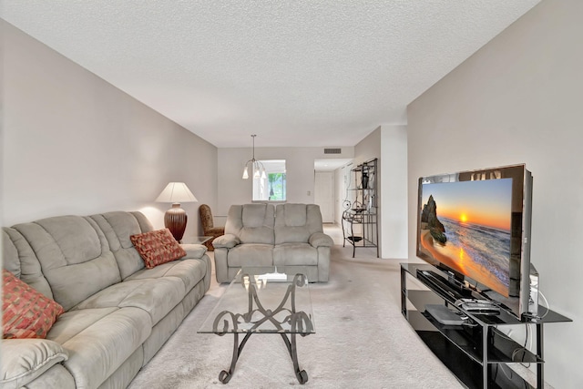 living room with light carpet and a textured ceiling