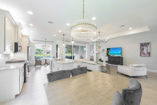 dining space with light tile flooring, sink, and an inviting chandelier