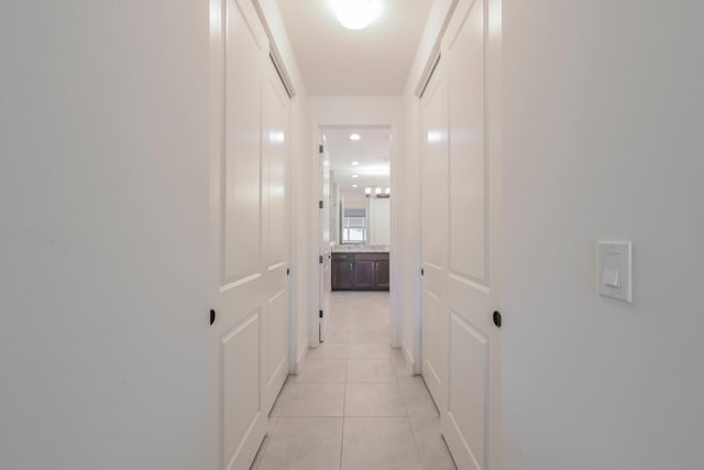 corridor featuring light tile floors