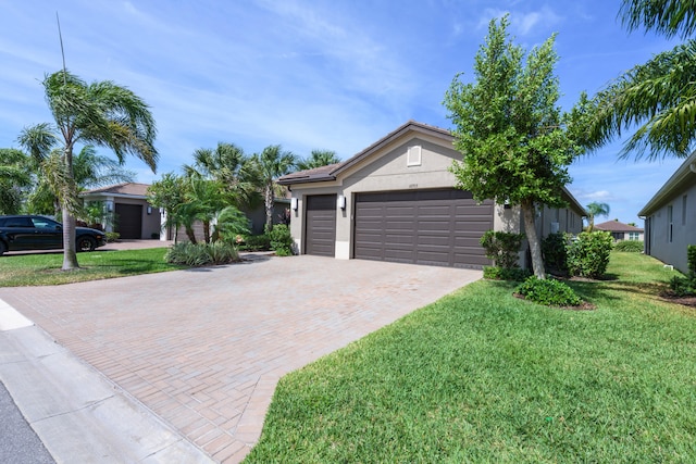 single story home featuring a garage and a front lawn