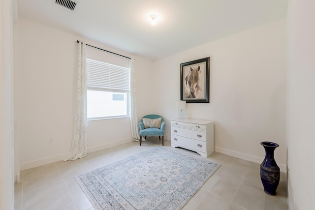 sitting room featuring light tile floors