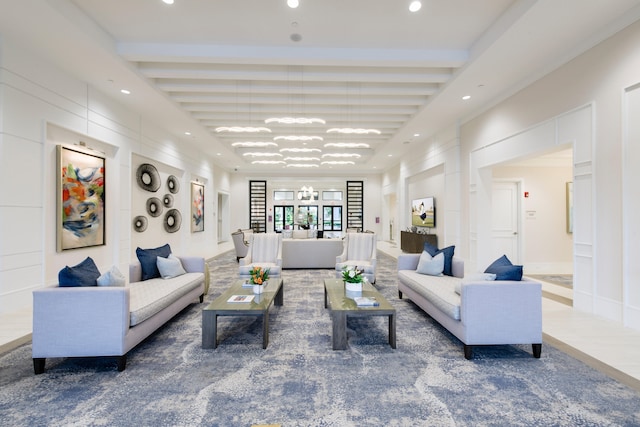 living room featuring an inviting chandelier, carpet flooring, and beam ceiling