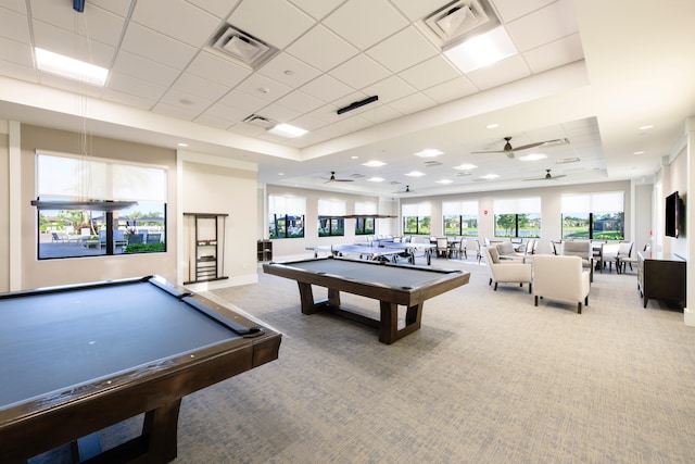 recreation room featuring pool table, carpet floors, ceiling fan, and a tray ceiling