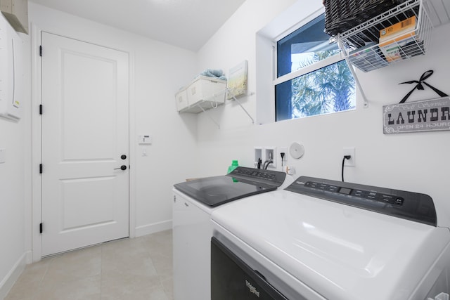 washroom featuring light tile floors, washer hookup, and separate washer and dryer