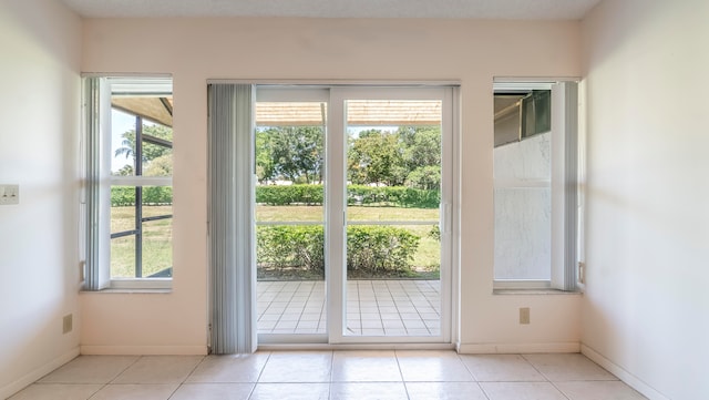 entryway with a wealth of natural light and light tile flooring