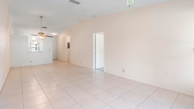 unfurnished room featuring vaulted ceiling, ceiling fan, and light tile floors