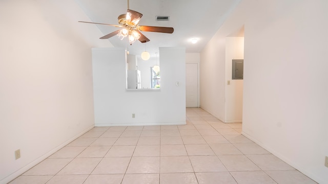 empty room with ceiling fan and light tile floors