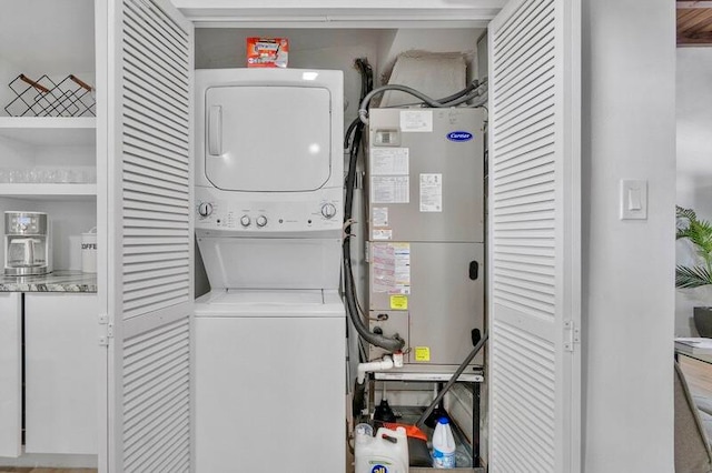 washroom featuring stacked washer and clothes dryer