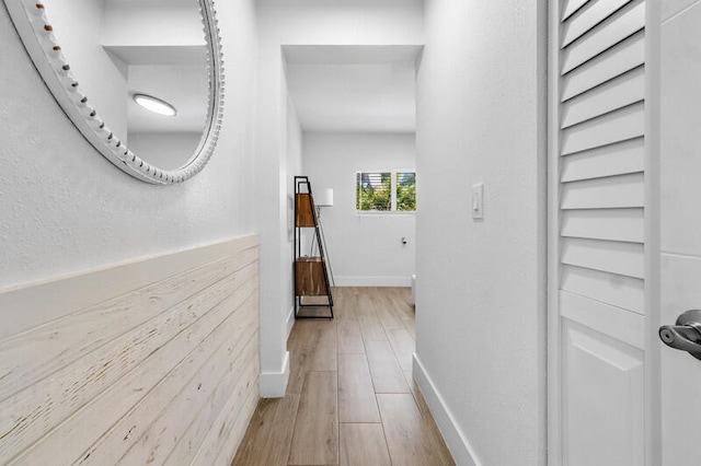 corridor with hardwood / wood-style floors