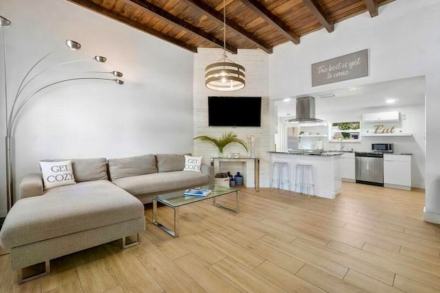 living room with wood ceiling, lofted ceiling with beams, brick wall, and light wood-type flooring