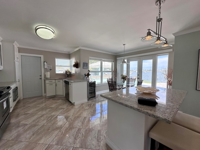 kitchen featuring decorative light fixtures, a water view, light tile patterned floors, and white cabinetry