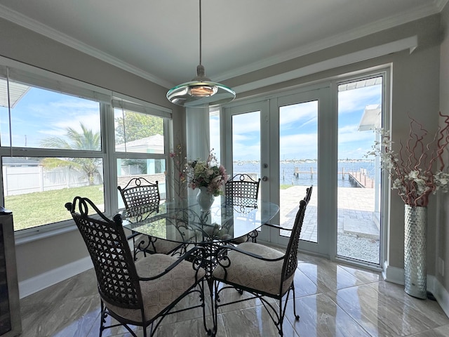 dining room with light tile patterned flooring, a wealth of natural light, and crown molding