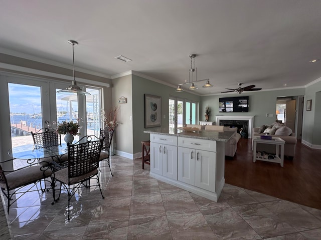 kitchen featuring ceiling fan, french doors, white cabinetry, hardwood / wood-style flooring, and crown molding