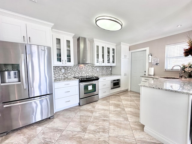 kitchen with wall chimney range hood, backsplash, light stone countertops, sink, and stainless steel appliances