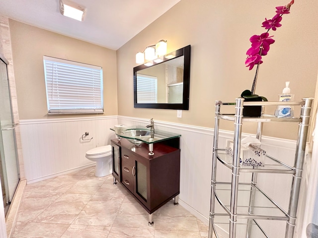 bathroom featuring tile patterned floors, a shower with shower door, vanity, and toilet