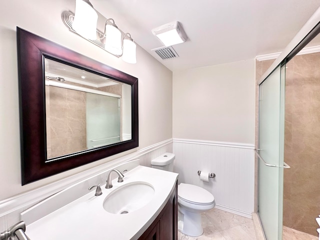 bathroom featuring toilet, vanity, a shower with door, and tile patterned floors