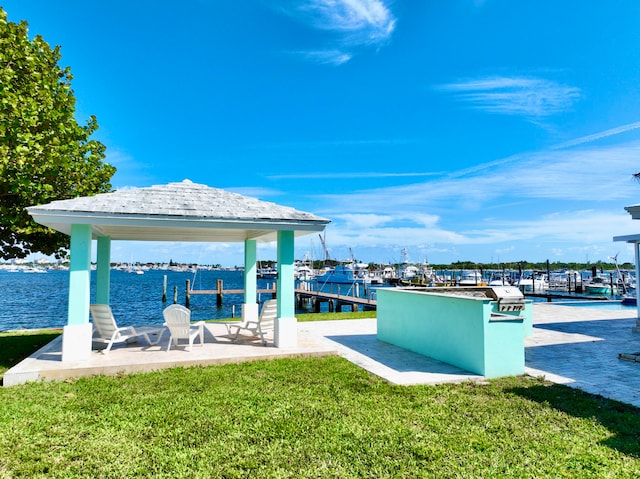 view of dock featuring a yard and a water view