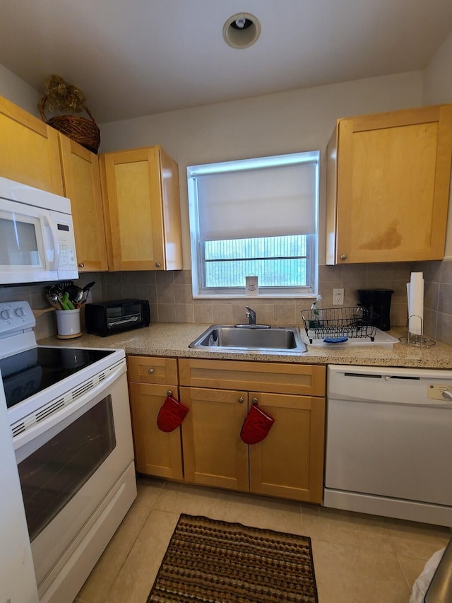 kitchen featuring light tile patterned floors, tasteful backsplash, white appliances, and sink