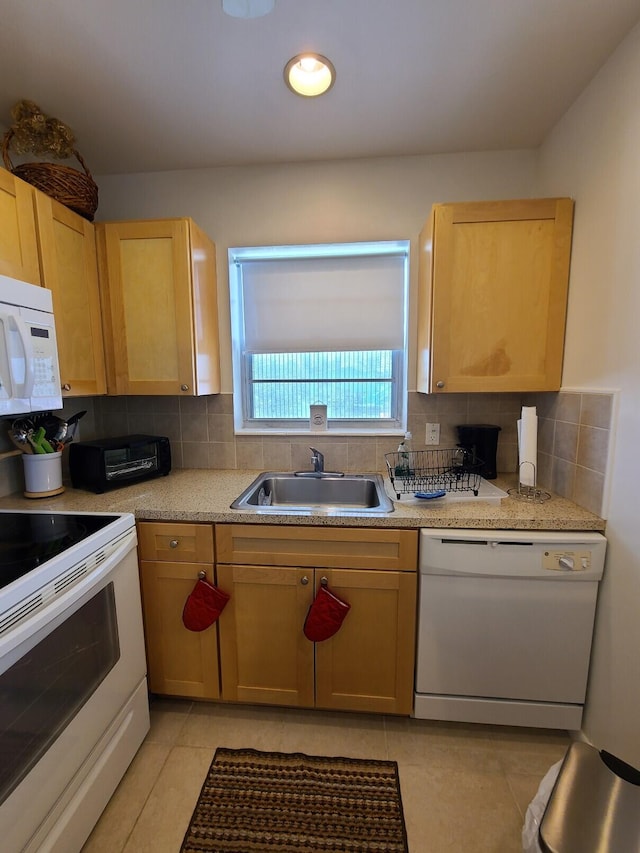 kitchen with light tile patterned floors, white appliances, tasteful backsplash, and sink