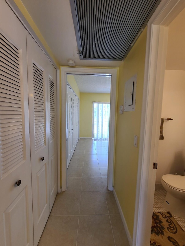 hallway with tile patterned floors