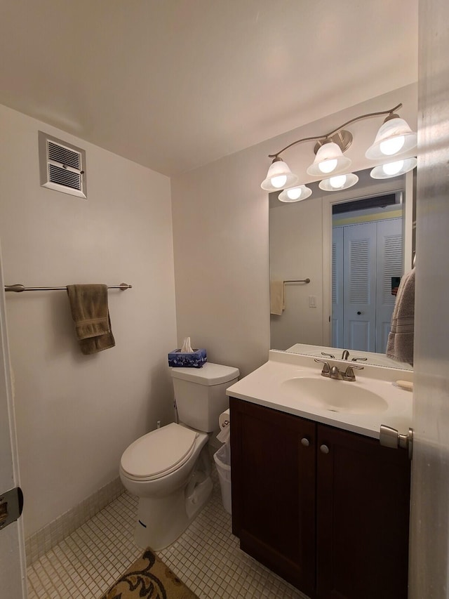 bathroom with vanity, tile patterned flooring, and toilet