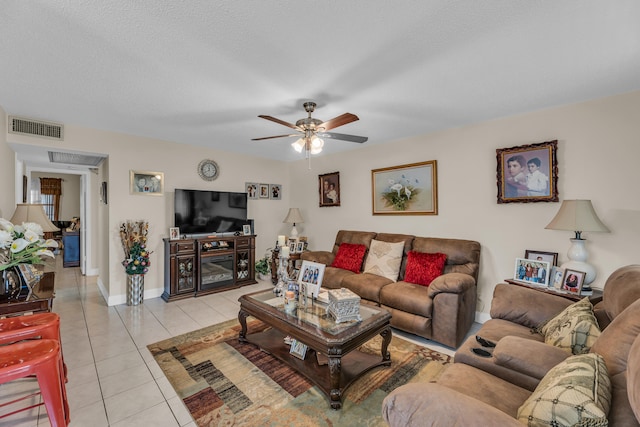 tiled living room featuring a textured ceiling and ceiling fan