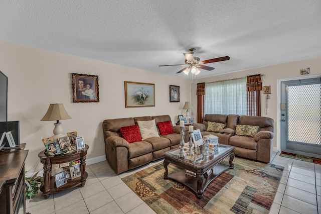 tiled living room featuring ceiling fan and a textured ceiling