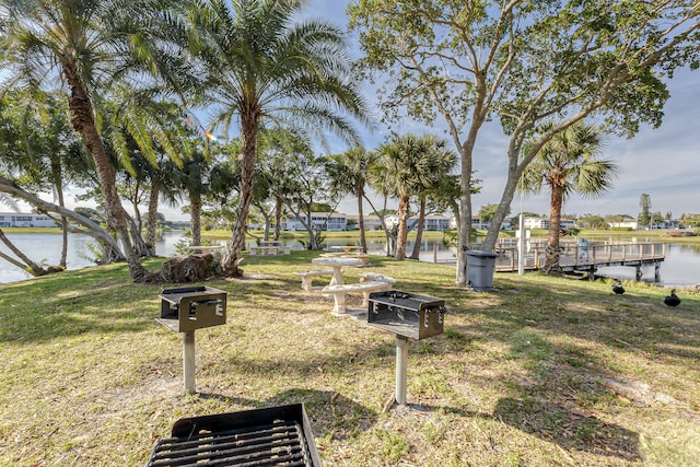 view of yard featuring a boat dock and a water view