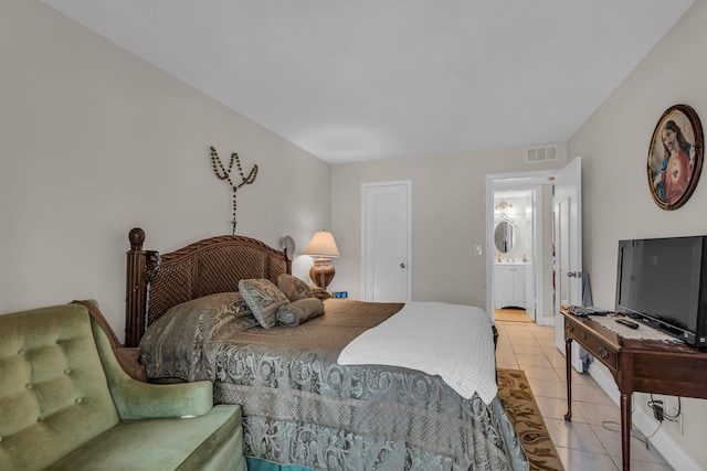 bedroom featuring tile flooring, a closet, and ensuite bath