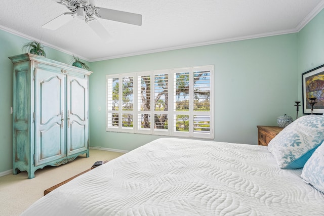 carpeted bedroom featuring ornamental molding, ceiling fan, and a textured ceiling