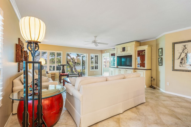 living room featuring light tile flooring, ceiling fan, and crown molding