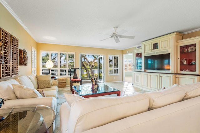 tiled living room with ornamental molding and ceiling fan