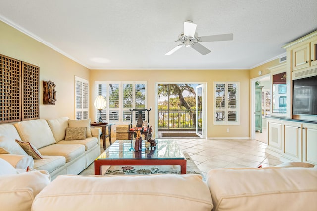 living room featuring ceiling fan, light tile flooring, crown molding, and a textured ceiling