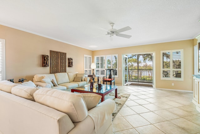 living room with ornamental molding, ceiling fan, and light tile flooring