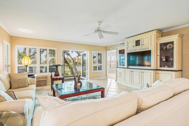 tiled living room with crown molding, ceiling fan, and a textured ceiling