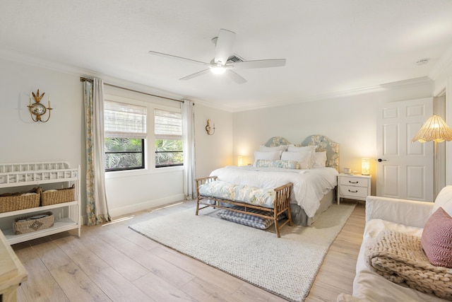 bedroom featuring ceiling fan, light wood-type flooring, and crown molding